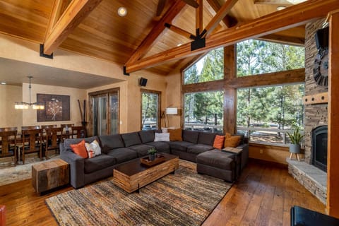 Open concept living between great & dining room with cedar, vaulted ceiling