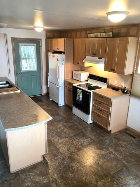 Kitchen with dishwasher, spices, cooking oils and condiments provided.