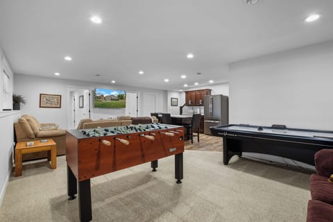 Lower level with game room, smart TV, and wet bar with ice maker