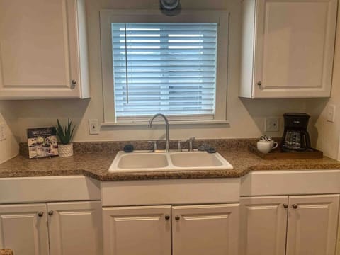 Unique kitchen space - plenty of counter space - refrigerator, microwave, oven, electric stove and all supplies needed for a home cooked meal.