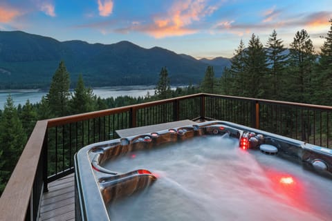 Luxurious 6 person hot tub with mountain and lake views.
