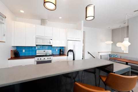 Kitchen fully stocked with dishware and cookware.