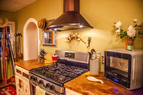 Gas stove, and all new distressed cabinetry w/ red willow detailing.