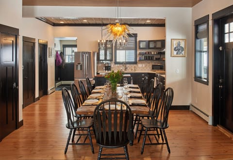 The hand-made dining room table can seat ten guests and is extra wide for ample elbow room.