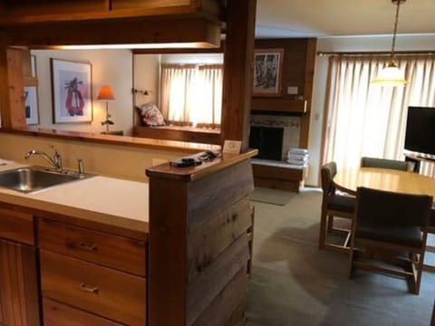 Kitchen, dining, and living room. Patio door and fireplace.