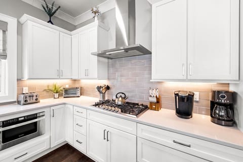 The kitchen has plenty of counter space and a gas stove.