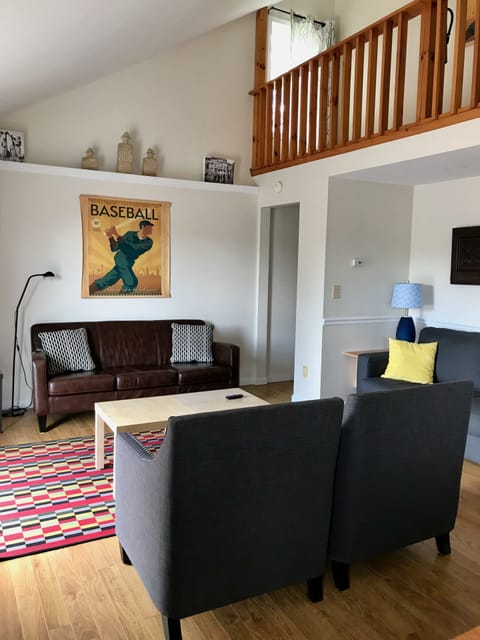 Comfy living room with cathedral ceiling and sliding door to deck.