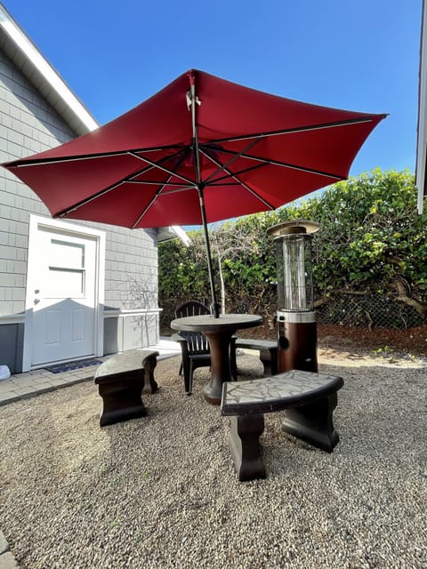 Concrete patio set with gas heater outside of the guest suite. 