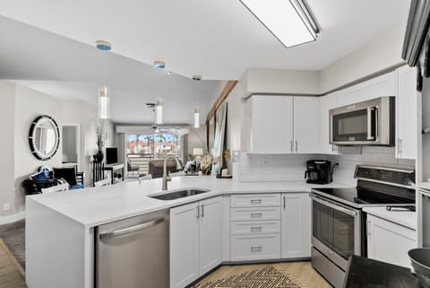 View from kitchen to den and outside