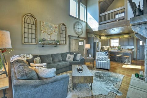 Luxurious living room with stone gas fireplace, smart/satellite TV, and cozy furniture