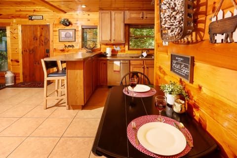 Kitchen view with dinette and bar stools.