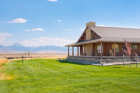 A large mowed lawn surrounds this cabin,  providing  plenty of play space.