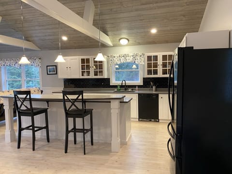 Large fully stocked kitchen features a island for seating