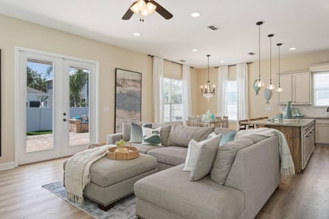 Bright open living room with views of the pool