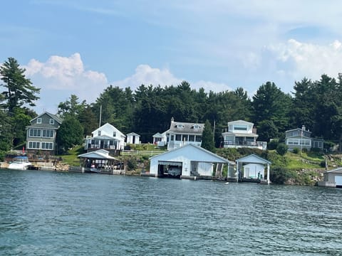 Blue Roofed Boatlift with Cottage above. House is Tallest one on this road.