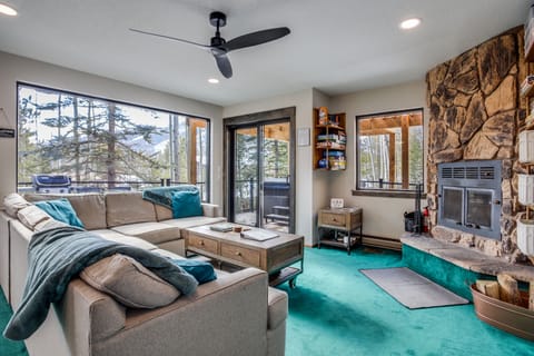 Bright and cozy living area with mountain views, fireplace, and 75" smart TV