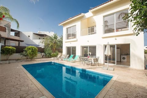 Pool area with sun loungers, outside dining and barbecue