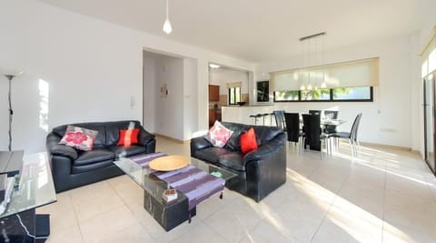 Living room with leather sofas and widescreen TV
