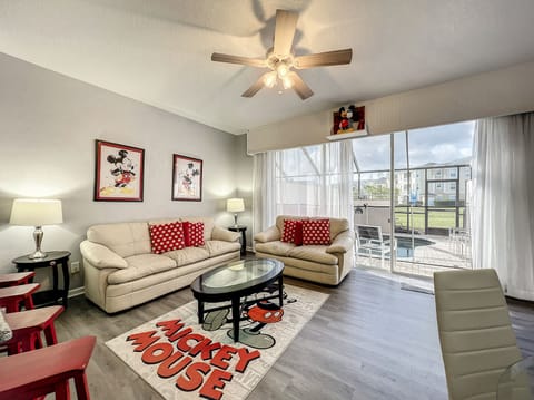 Bright Disney-themed living room with natural light, perfect for relaxing after a fun day.