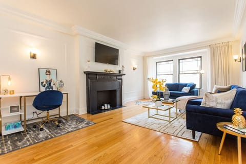 Welcome to the GUILD - a FULL FLOOR 6bd/6ba home in Gold Coast, a block from Mag Mile! Wifi here is up to 500 MBPS.Pictured here is one of our living rooms with a sofa, desk, 50” Smart TV, Chaise, and gilded decor
