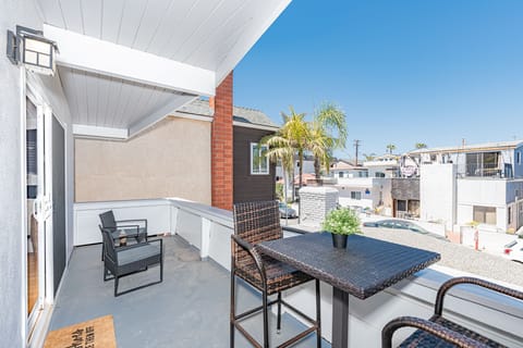 The front patio includes seating for four and a propane BBQ grill for sunset cookouts.