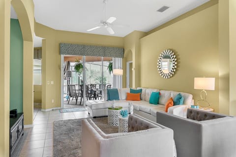 Stylish open-plan living area with sliding doors to the pool deck
