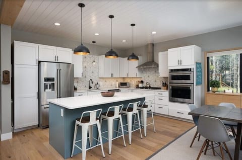 Beautiful well equipped kitchen with stainless steel appliances and gas range