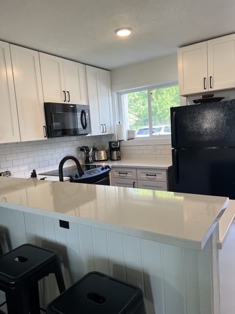 Kitchen with breakfast bar seating for four