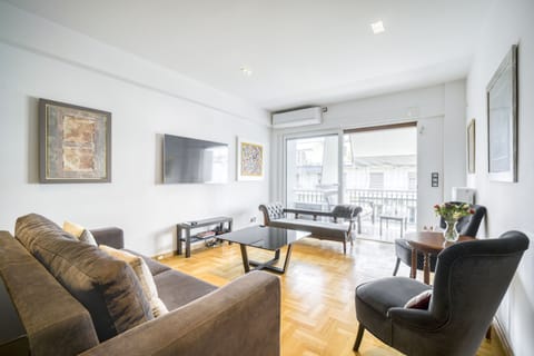 Main living area opening on to balcony lounge, independent  AC and smart TV