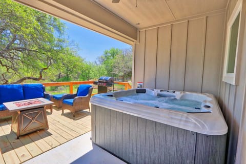 Covered hot tub next to the entertaining area