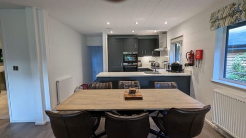 Dining area with kitchen beyond