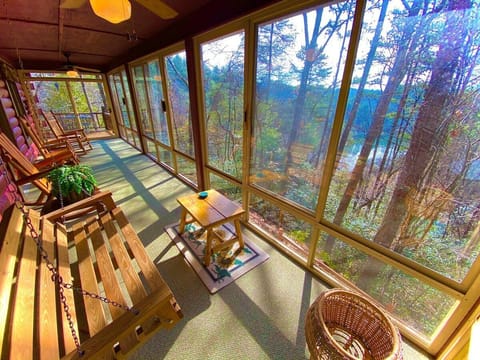 A view from the opposite end of the massive sunroom. Can't you just see yourself rocking away the evening, gazing
at the private lake that peeks through the trees and listening to the many birds happily chirping their morning songs?