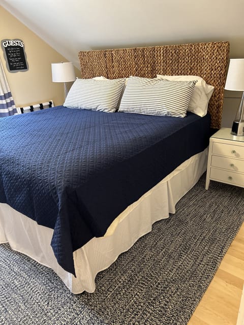 King bedroom with newly installed maple floors. New nightstands, and lamps.