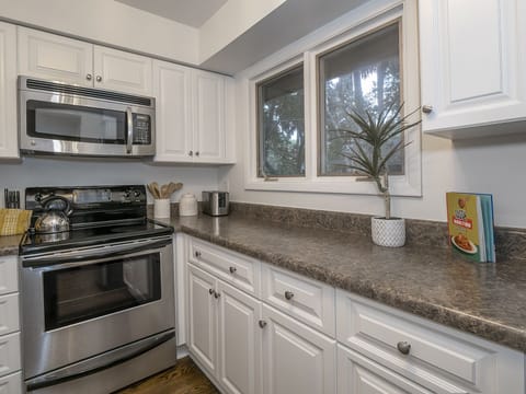 The beauty of the outdoors stream through the kitchen windows