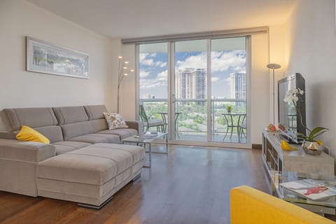 Spacious living room with a dining table and convertible sofas.