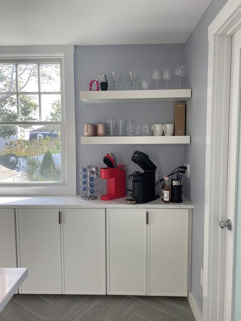 Nespresso machine, cream foamer, and Keurig machine.Plenty of mugs and glassware