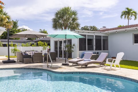 Private backyard with pool and comfortable seating.