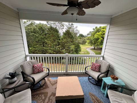 Balcony with 4 swivel rockers and ottoman, overlooking the Norman course