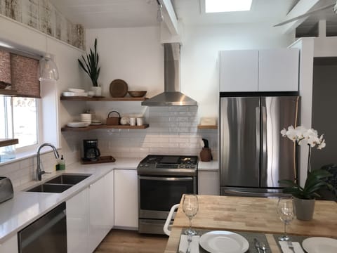 The kitchen features a gas range and a built in washer/dryer.