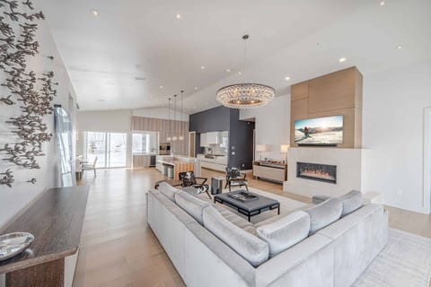 The Gourmet Kitchen Features a Complete Range of High-End appliances Including a 6 Burner Wolf Gas Range and Oven, Large White Quartz Island