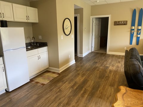 Lower level wet bar with refrigerator.