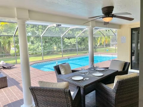 Our enclosed pool area features premium furniture, a heated pool, and a TV!