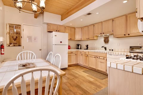 Fully equipped cabin kitchen with ample cabinetry, stove, fridge, microwave, and coffee maker—perfect for cooking meals, morning coffee, and feeling right at home on your stay.
