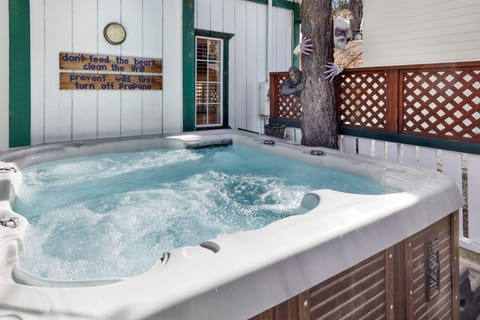 Private outdoor hot tub surrounded by tall pines, perfect for relaxing under the trees after a day of adventure—enjoy peaceful forest views, fresh air, and a truly rejuvenating stay.