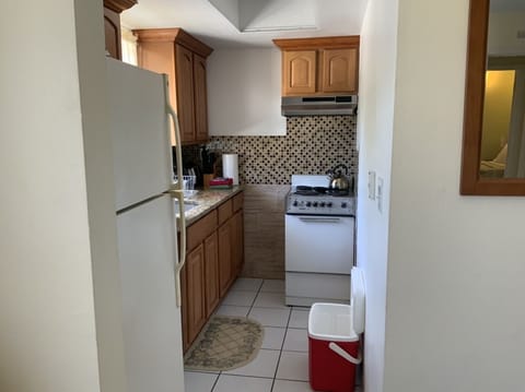 Fully equipped kitchen with all cooking and serving items, pots, pans, glassware