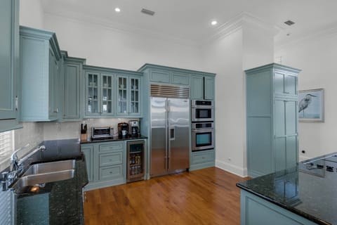 Large well appointed kitchen with stainless steel appliances.