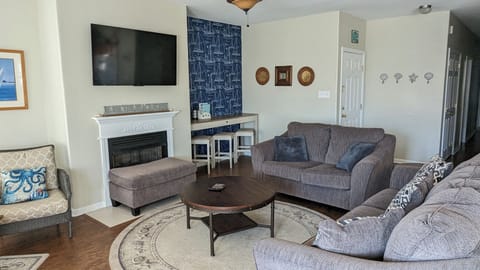 Spacious living room with ample seating. Back nook perfect for working remotely.