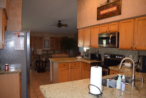 Kitchen is adjacent to the living area and dining room.
