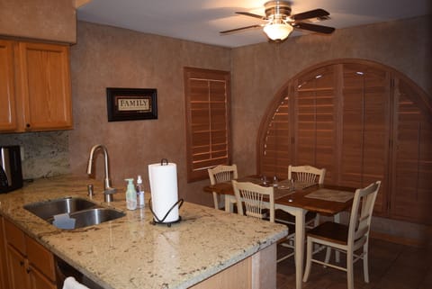 Separate eating area in the kitchen seats 4.   Ceiling fan above table.