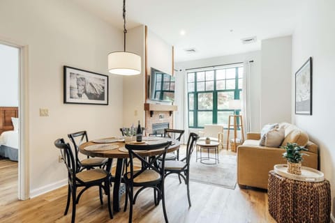 Bright dining and living area with cozy seating and natural light